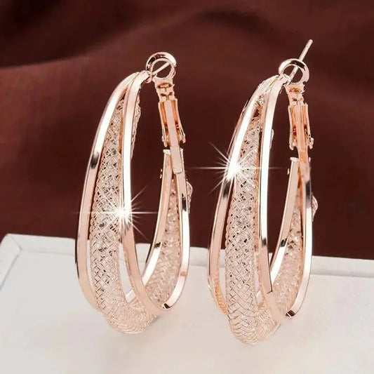 Boucles d'oreilles : Créoles torsadées en or et argent avec cristaux